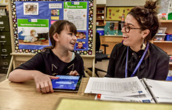 Student & Mentor Laughing in the Classroom